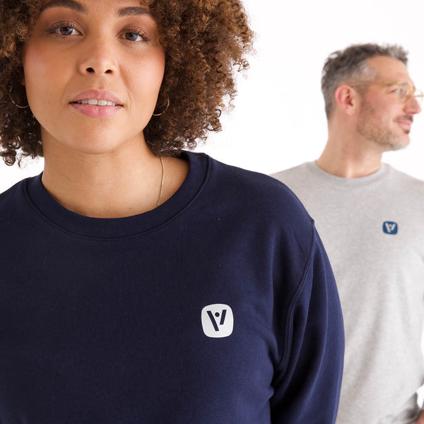Detailansicht des dunkelblauen veercrew Sweatshirts "Solid" mit kleinem Logo-Print, getragen von einer Frau